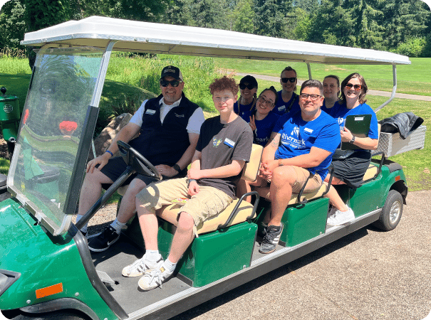 Rivermark volunteers in a golf cart.