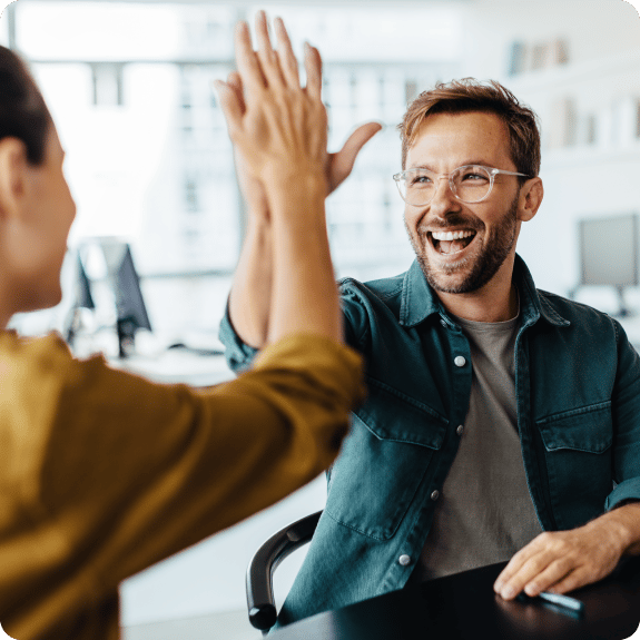 Man high fiving a friend.