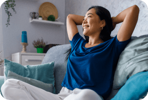 Happy woman lounging on a couch.